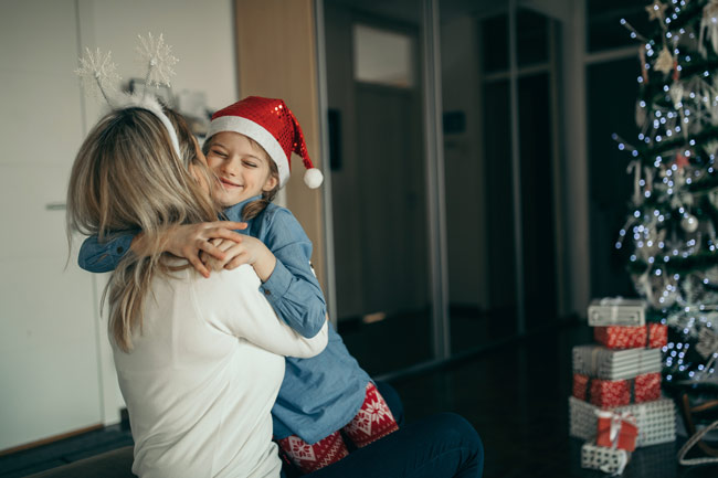 Mother and child hugging at Christmas