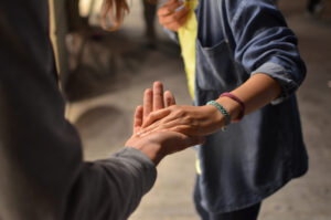 two volunteers holding hands