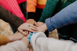 team of women's hands placed on top of each other