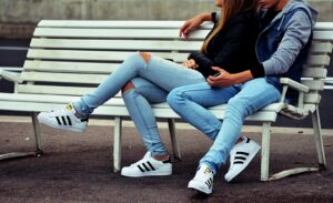 photo of couple sitting on white bench - healthy relationships